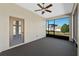 Enclosed lanai with gray carpet, a ceiling fan with a light and a view of the backyard at 3608 Mount Hope Loop, Leesburg, FL 34748