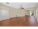 Sunlit living area with sleek wood floors, neutral tones, and arched doorways leading to other rooms at 3608 Mount Hope Loop, Leesburg, FL 34748