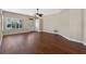 Open-concept living room with wood floors and neutral paint, with lots of natural light from windows at 3608 Mount Hope Loop, Leesburg, FL 34748