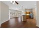 Open-concept living space with wood floors, seamlessly connecting the kitchen and dining areas at 3608 Mount Hope Loop, Leesburg, FL 34748