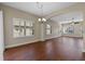 Spacious living room with pristine wood floors and plantation shutters, bathed in natural light at 3608 Mount Hope Loop, Leesburg, FL 34748