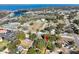 A picturesque aerial shot highlighting a neighborhood with its homes, nearby waterfront, and adjacent roads at 418 N Barrow Ave, Tavares, FL 32778