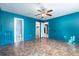 Bedroom with colorful walls, updated flooring, and multiple doors leading to other rooms at 418 N Barrow Ave, Tavares, FL 32778