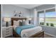 Cozy bedroom with light blue bedding and a large window at 4265 Singing Mockingbird Blvd, Bartow, FL 33830