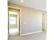 Large bedroom with neutral paint, white trim, a window, light wood floors and two doors at 4425 Lions Gate Ave, Clermont, FL 34711