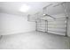 Spacious two car garage featuring overhead storage and white painted walls at 4425 Lions Gate Ave, Clermont, FL 34711