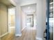 Bright hallway features wood-look floors and neutral paint, illuminated with recessed lighting for a modern feel at 4425 Lions Gate Ave, Clermont, FL 34711