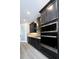 Modern kitchen featuring sleek, dark cabinetry, stainless steel appliances and stylish backsplash at 4425 Lions Gate Ave, Clermont, FL 34711