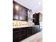 Modern kitchen with dark cabinets, stainless steel hood, and geometric backsplash at 4425 Lions Gate Ave, Clermont, FL 34711