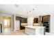 Modern kitchen features an island, stainless steel appliances and hardwood floors at 4425 Lions Gate Ave, Clermont, FL 34711