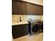 Laundry room showcasing modern washer, dryer and overhead cabinets at 4425 Lions Gate Ave, Clermont, FL 34711
