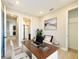Inviting home office space with a large desk, comfortable chair, and natural light at 4425 Lions Gate Ave, Clermont, FL 34711