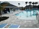Sparkling community pool featuring lounge chairs, umbrellas and an inviting pool deck at 4425 Lions Gate Ave, Clermont, FL 34711