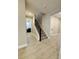 Staircase with black metal railing and wood-look flooring leading to the second level of the home at 4425 Lions Gate Ave, Clermont, FL 34711