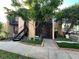 Updated condo with exterior features including a staircase and landscaped area at 4854 S Semoran Blvd # 2203, Orlando, FL 32822