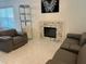 Spacious living room with fireplace and modern furniture at 4854 S Semoran Blvd # 2203, Orlando, FL 32822