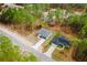 Aerial view of single Gathering homes among the trees, with long driveways, and neutral colors at 6732 Sw 132Nd St, Ocala, FL 34473