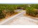 An intersection in a forested area with homes on opposite sides of the road, seen from an aerial view at 6732 Sw 132Nd St, Ocala, FL 34473