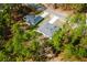 Single Gathering homes near each other surrounded by a canopy of beautiful green trees from an aerial view at 6732 Sw 132Nd St, Ocala, FL 34473