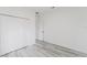 Empty bedroom with a large closet and wood-look flooring at 6732 Sw 132Nd St, Ocala, FL 34473