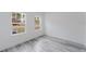 Bright bedroom with two windows and wood-look flooring at 6732 Sw 132Nd St, Ocala, FL 34473