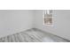 Empty bedroom with wood-look floors and one window at 6732 Sw 132Nd St, Ocala, FL 34473