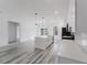 Modern kitchen featuring white cabinetry, island, stainless steel appliances, and hardwood floors at 6732 Sw 132Nd St, Ocala, FL 34473