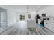 Modern kitchen featuring white cabinetry, island, stainless steel appliances, and hardwood floors at 6732 Sw 132Nd St, Ocala, FL 34473