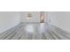Bright living room with wood-look flooring, light walls, and a modern door at 6732 Sw 132Nd St, Ocala, FL 34473
