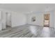 Spacious living room featuring wood-look floors, lots of natural light and a modern front door at 6732 Sw 132Nd St, Ocala, FL 34473