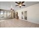 Spacious sunroom with tiled floors, ceiling fans and French doors at 6749 Crescent Ridge Rd, Orlando, FL 32810