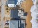 An aerial view showcases the beach house with modern architecture and a spacious deck overlooking the ocean at 6877 S Atlantic Ave, New Smyrna Beach, FL 32169