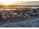 This aerial view captures the coastal homes at sunset, nestled between the serene ocean and the tranquil bay at 6877 S Atlantic Ave, New Smyrna Beach, FL 32169