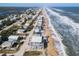 An aerial view showcases the beachside property's location between the ocean and the intercoastal waterway at 6877 S Atlantic Ave, New Smyrna Beach, FL 32169