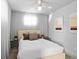 Bedroom featuring neutral tones, window lighting, and minimalist decor at 6877 S Atlantic Ave, New Smyrna Beach, FL 32169