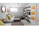Shared bedroom with three beds, modern decor, and floating bookshelves at 6877 S Atlantic Ave, New Smyrna Beach, FL 32169