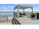 Outdoor dining area on the deck with ocean views and a shaded pergola, perfect for alfresco meals and relaxation at 6877 S Atlantic Ave, New Smyrna Beach, FL 32169