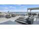 Expansive deck with stylish gray outdoor seating, offering stunning ocean views perfect for relaxing and entertaining guests at 6877 S Atlantic Ave, New Smyrna Beach, FL 32169