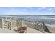 Cozy outdoor seating area on the deck, offering scenic ocean views and a tranquil space to unwind and enjoy the coastal breeze at 6877 S Atlantic Ave, New Smyrna Beach, FL 32169
