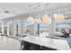 Bright dining room with modern table, chairs, lighting, and floor to ceiling windows providing a scenic view at 6877 S Atlantic Ave, New Smyrna Beach, FL 32169