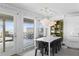 Bright dining room with modern table, chairs, and floor to ceiling windows providing an ocean view at 6877 S Atlantic Ave, New Smyrna Beach, FL 32169