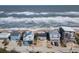 This oceanfront home features a gray exterior, private parking, and breathtaking views of the coastline at 6877 S Atlantic Ave, New Smyrna Beach, FL 32169