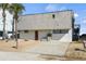 Street view of a charming single-Gathering home with a tidy exterior, complemented by sandy landscaping and a neat driveway at 6877 S Atlantic Ave, New Smyrna Beach, FL 32169