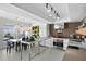 Bright kitchen featuring modern cabinets, kitchen island, stainless steel appliances, and adjacent dining area at 6877 S Atlantic Ave, New Smyrna Beach, FL 32169
