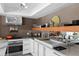 Modern kitchen featuring stainless steel appliances, countertop space, and sleek white cabinetry at 6877 S Atlantic Ave, New Smyrna Beach, FL 32169