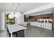Bright kitchen featuring modern cabinets, kitchen island, stainless steel appliances, and adjacent dining area at 6877 S Atlantic Ave, New Smyrna Beach, FL 32169