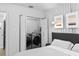 Bedroom featuring a hidden laundry closet and a large upholstered headboard at 6877 S Atlantic Ave, New Smyrna Beach, FL 32169