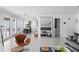 Bright living room featuring stylish furniture, white walls, and large mirror reflecting the interior design at 6877 S Atlantic Ave, New Smyrna Beach, FL 32169