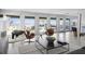A spacious living room featuring comfortable seating, modern decor, and views of the ocean at 6877 S Atlantic Ave, New Smyrna Beach, FL 32169