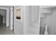Bright, white staircase with artwork leading to other parts of the home at 6877 S Atlantic Ave, New Smyrna Beach, FL 32169
